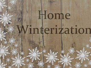 "home winterization" written on a wooden background with snowflakes. A complete checklist by solid state construction.