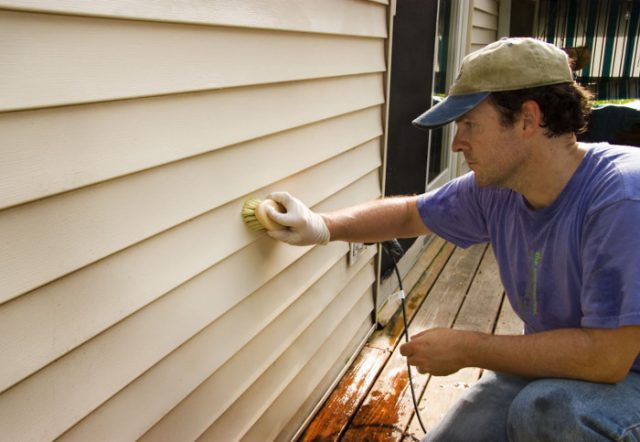 cleaning siding with a soft bristle brush 